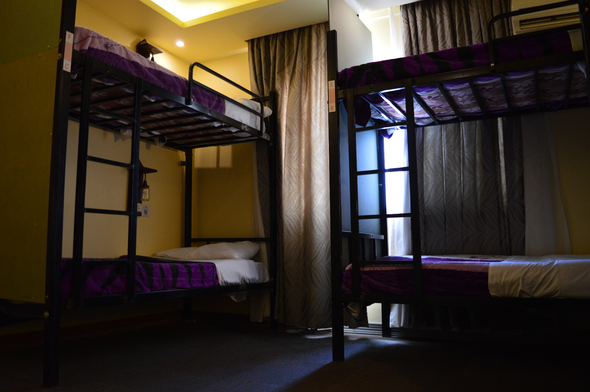 Dorm room with multiple bunk beds and window