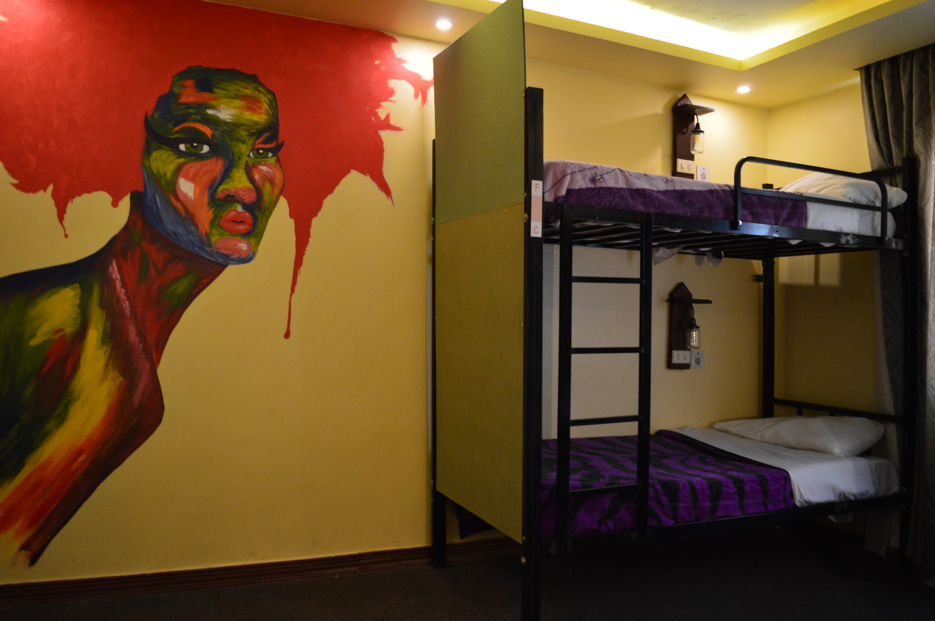 Dorm room bunk beds with painted mural