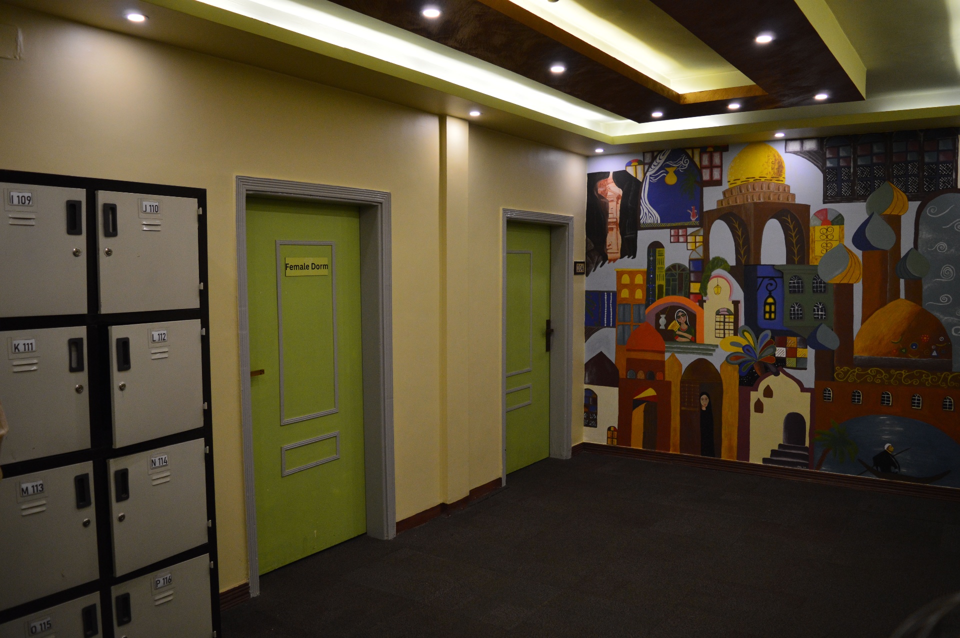 Female dorm entrance with lockers and hallway mural