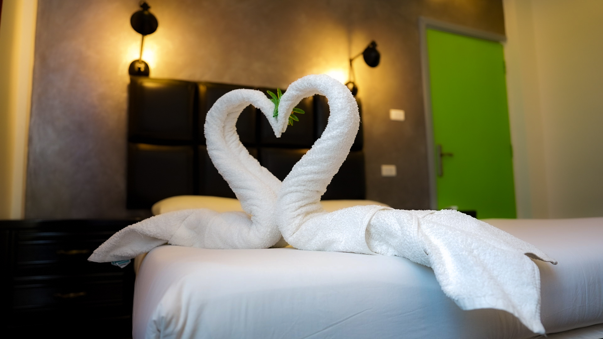 Towel art shaped as a heart on a private room bed