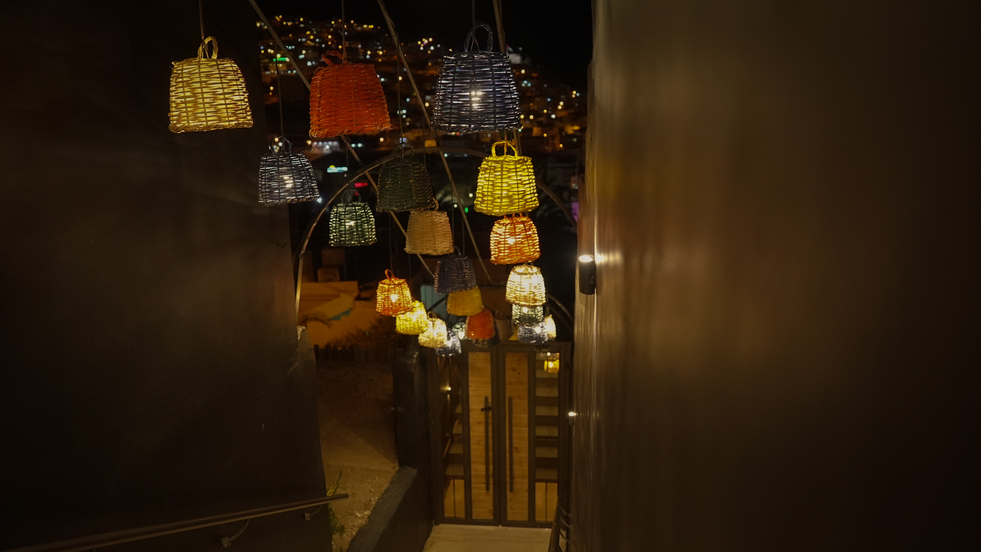 Lanterns over the entrance stairs at night with city lights
