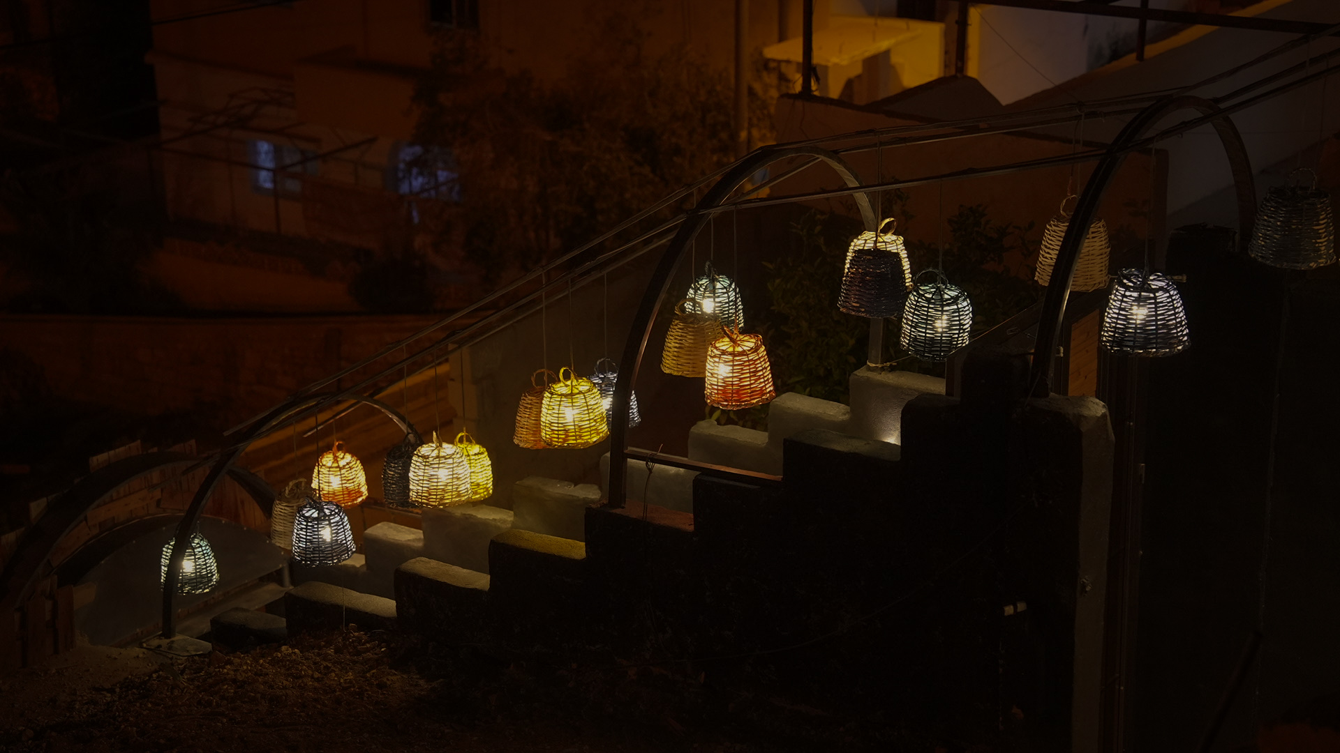 Entrance stairs at night lit with woven lanterns
