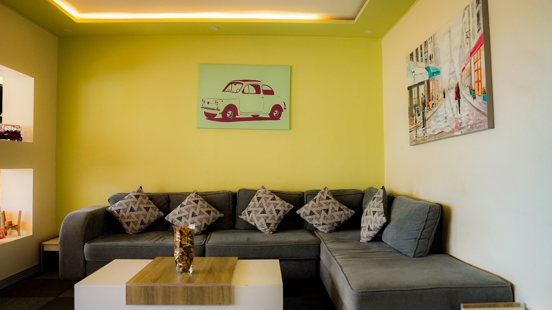 Lobby lounge with grey sofa and pop-art canvases