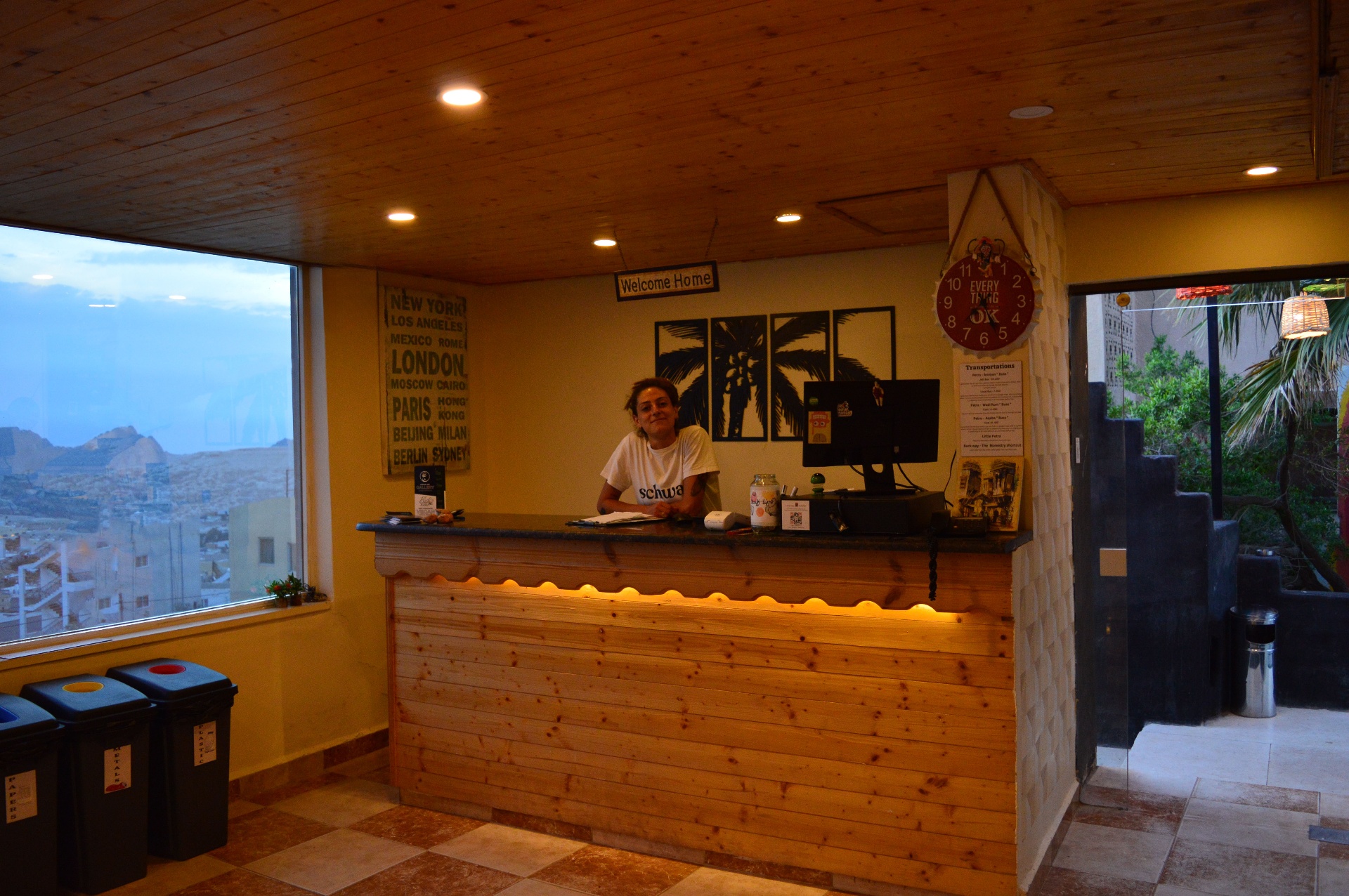 Rafiki Hostel reception with city view and recycling bins