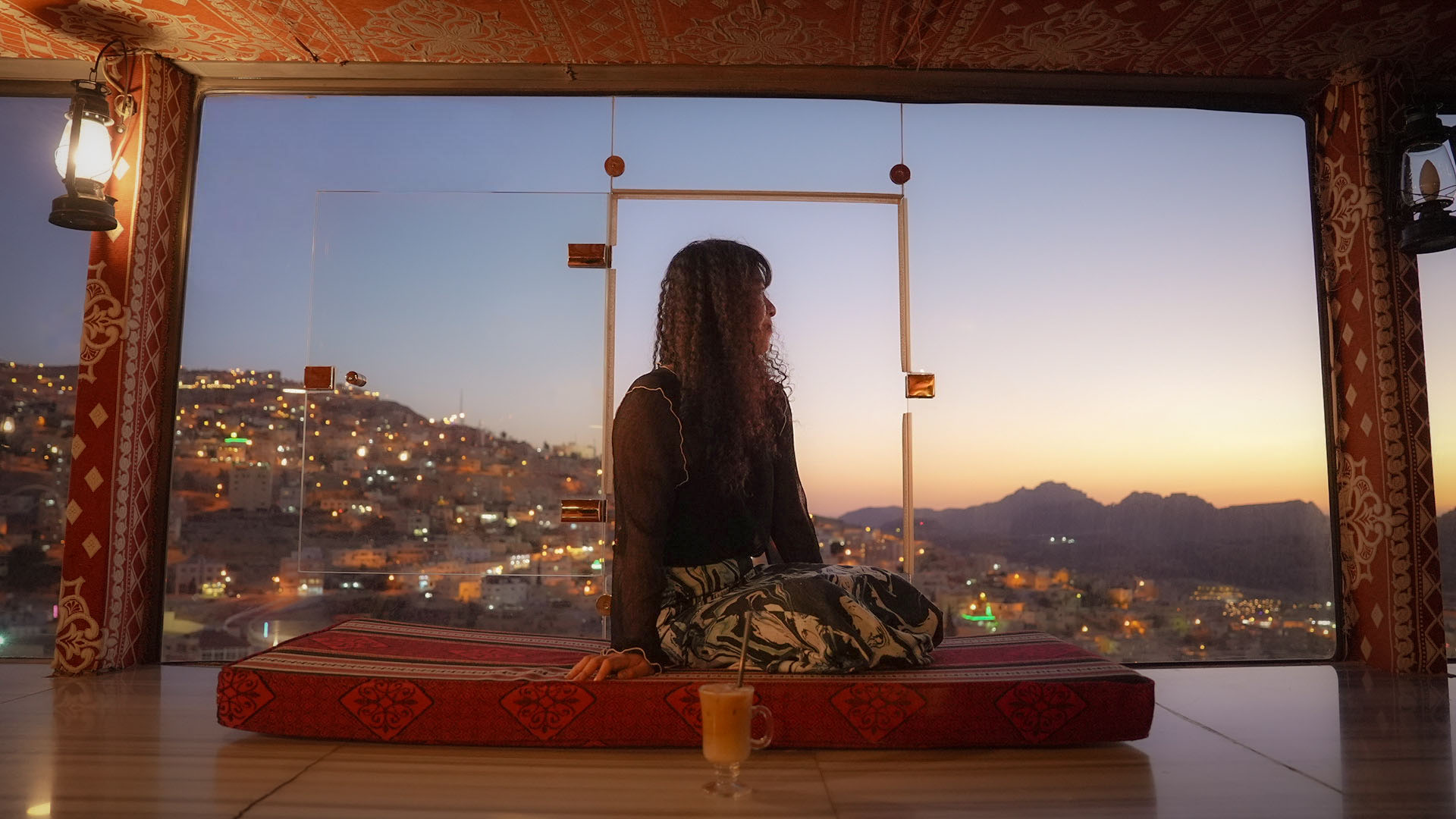 Guest watching the sunset over Petra mountains from the rooftop