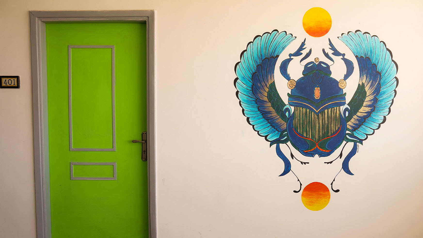 Room 401 with lime-green door and a winged scarab mural