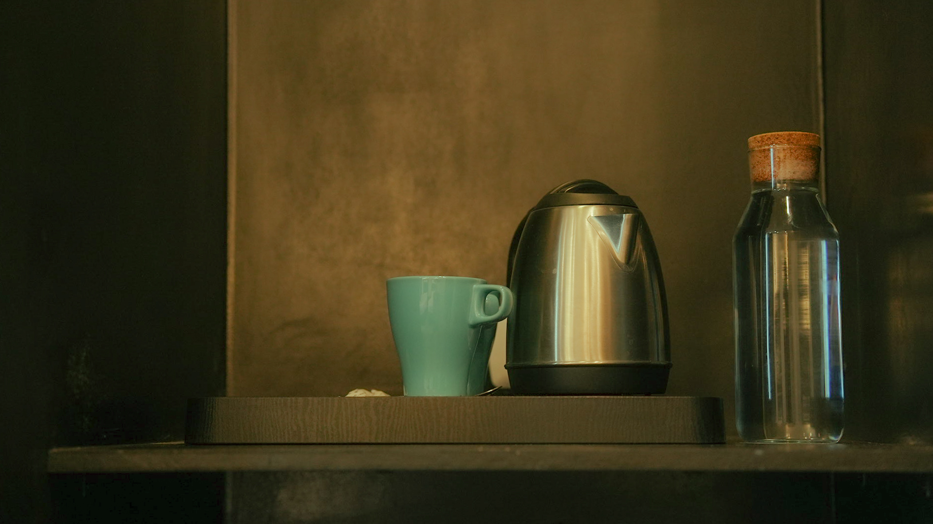 In-room tea kettle, cup and glass water bottle